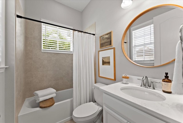 full bathroom featuring toilet, shower / bath combination with curtain, and vanity