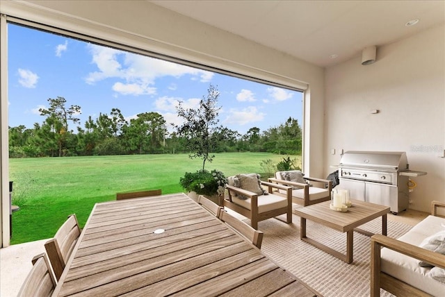 exterior space with grilling area, outdoor lounge area, and a yard