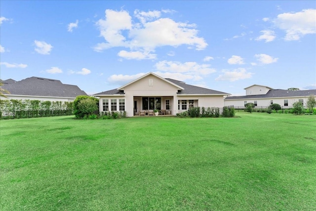 rear view of house with a lawn