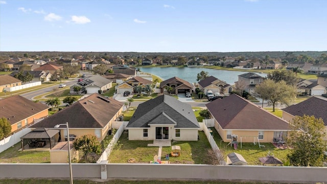 birds eye view of property with a residential view and a water view