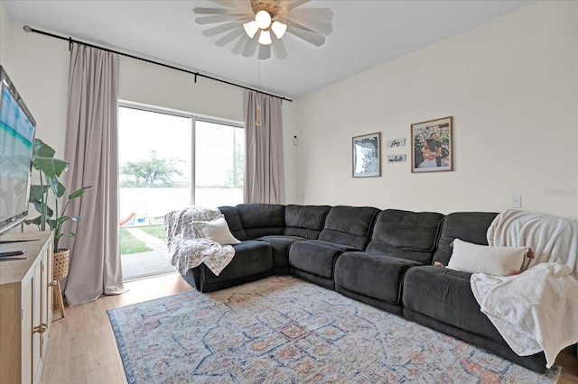 living area with light wood-style flooring and ceiling fan