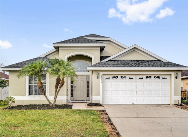 single story home featuring driveway, roof with shingles, and stucco siding