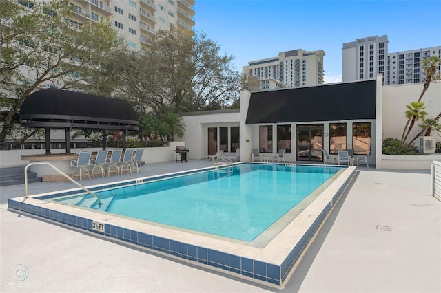 community pool featuring a patio and area for grilling