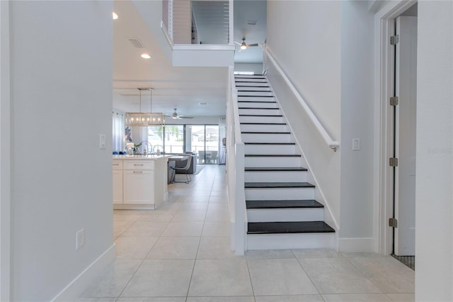 stairway featuring recessed lighting, visible vents, ceiling fan, baseboards, and tile patterned floors