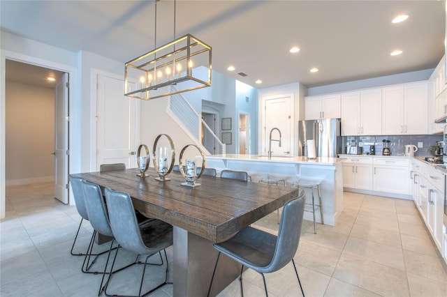 dining room featuring light tile patterned floors, stairs, visible vents, and recessed lighting