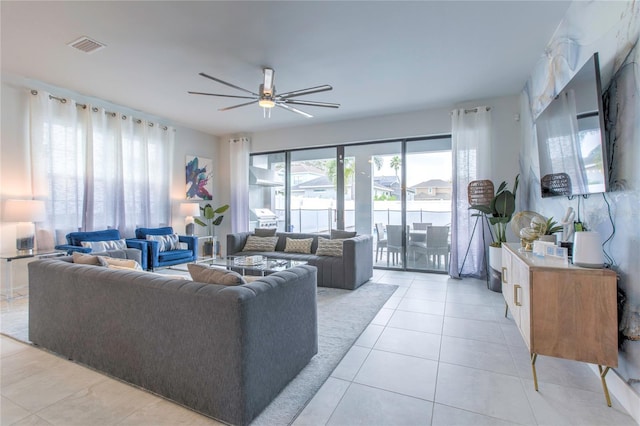 living area featuring visible vents, a ceiling fan, and light tile patterned flooring