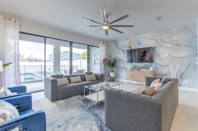 living area featuring visible vents, a ceiling fan, and light tile patterned flooring