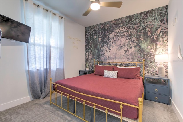 carpeted bedroom featuring baseboards and a ceiling fan