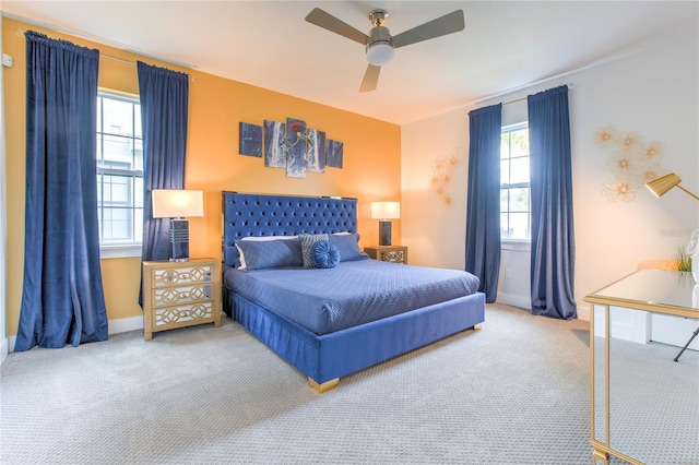 carpeted bedroom with a ceiling fan and baseboards