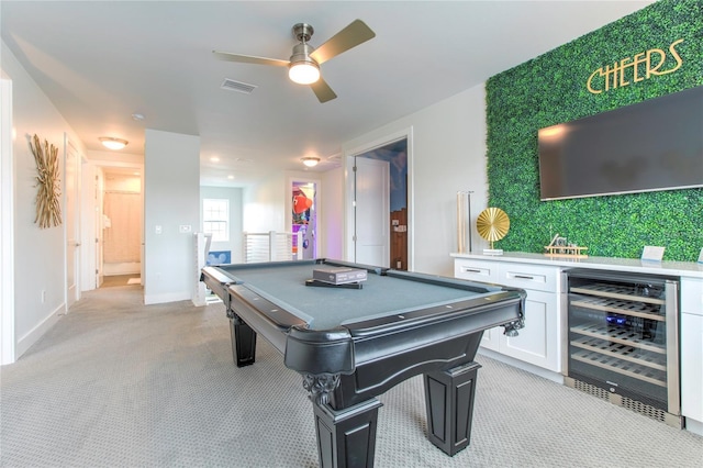 game room with light carpet, wine cooler, visible vents, and baseboards