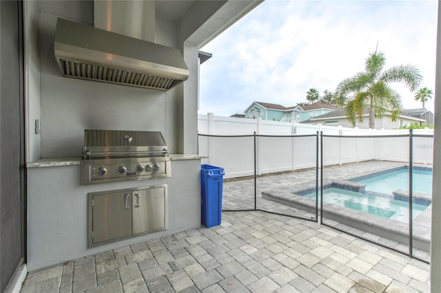 view of patio with a pool with connected hot tub, a fenced backyard, a grill, and an outdoor kitchen