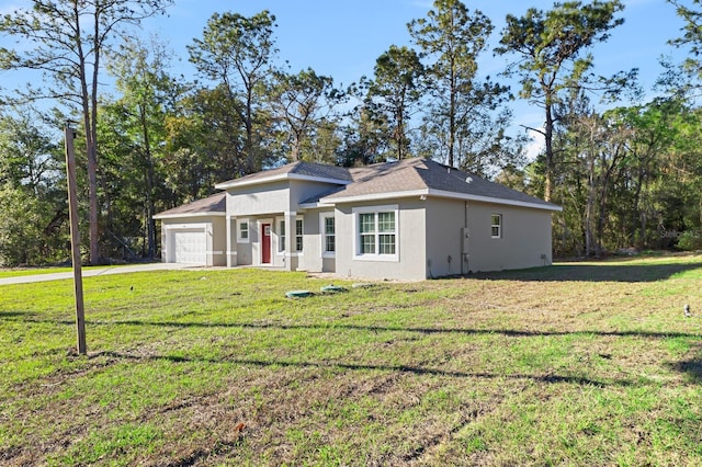 view of front of house with an attached garage, stucco siding, concrete driveway, and a front yard