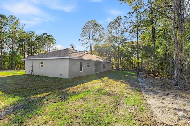 view of home's exterior featuring a yard and stucco siding