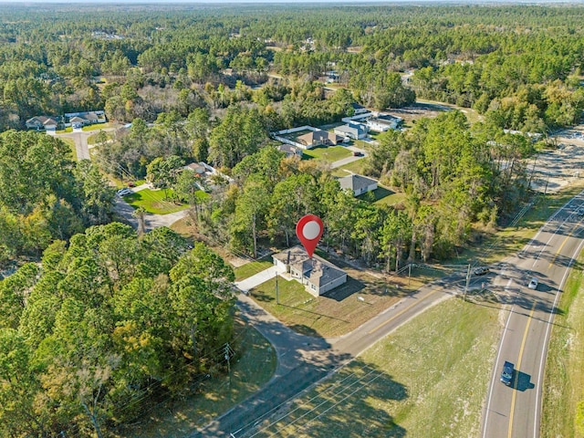 drone / aerial view featuring a view of trees