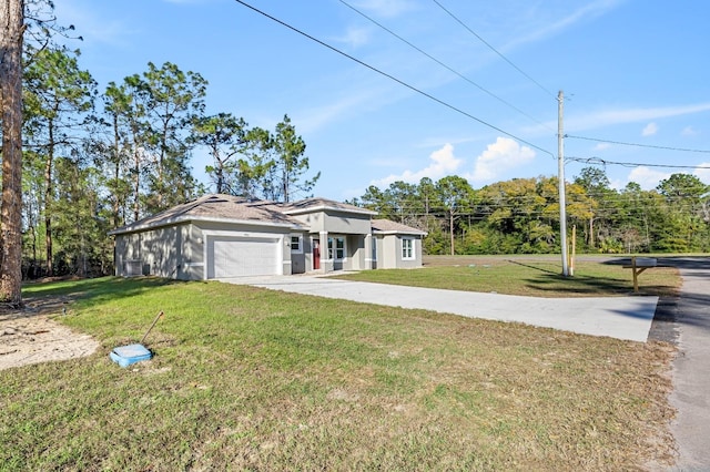 view of front of home featuring an attached garage, concrete driveway, and a front yard