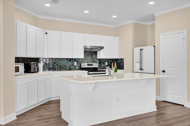 kitchen with light wood-style flooring, white appliances, a kitchen island with sink, and under cabinet range hood