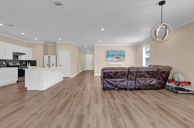 living room featuring ornamental molding, light wood finished floors, recessed lighting, and visible vents