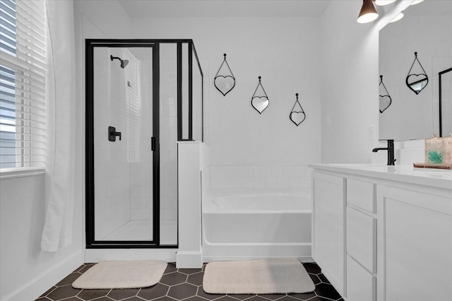 bathroom featuring a bath, tile patterned flooring, a shower stall, and vanity