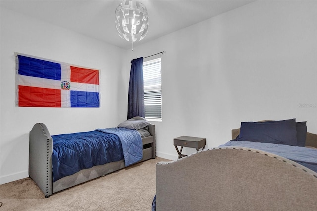 bedroom featuring carpet and baseboards