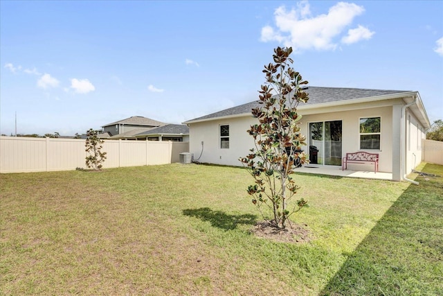 back of property featuring a yard, stucco siding, and fence