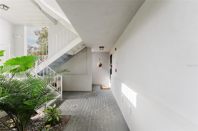 interior space featuring brick floor and stairway