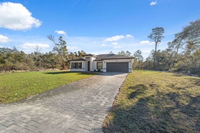 view of front of home featuring a garage, a front yard, decorative driveway, and stucco siding