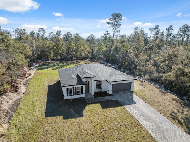 birds eye view of property featuring a view of trees