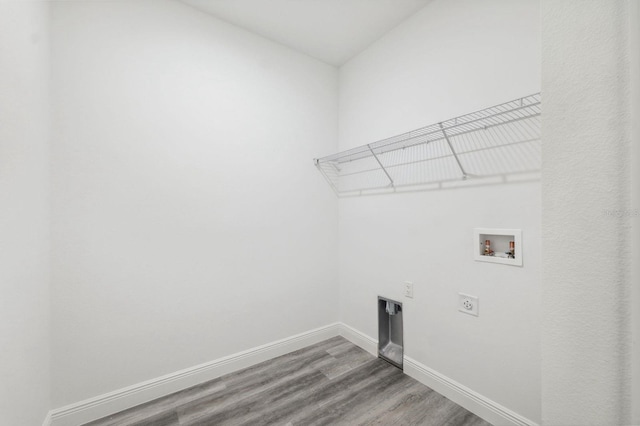 laundry room featuring laundry area, washer hookup, wood finished floors, baseboards, and electric dryer hookup