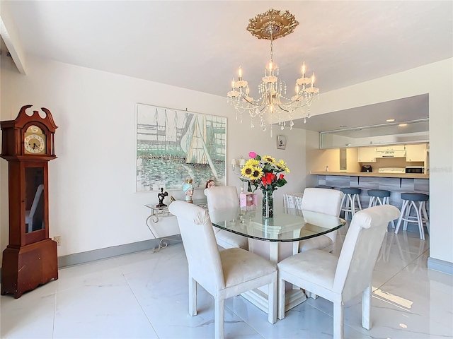 dining area with a notable chandelier, marble finish floor, and baseboards