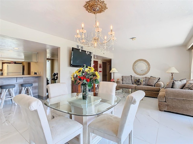 dining room with marble finish floor and a chandelier