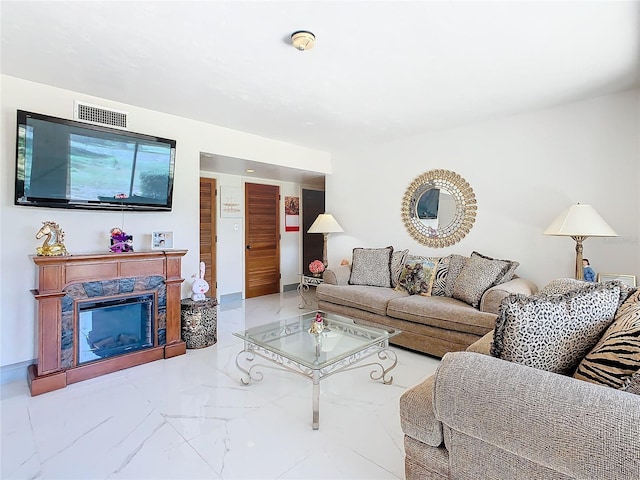 living room featuring a high end fireplace and marble finish floor