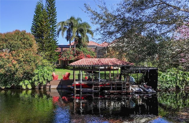 view of dock with boat lift and a water view