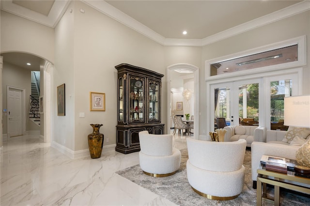 sitting room with stairway, baseboards, a high ceiling, crown molding, and marble finish floor