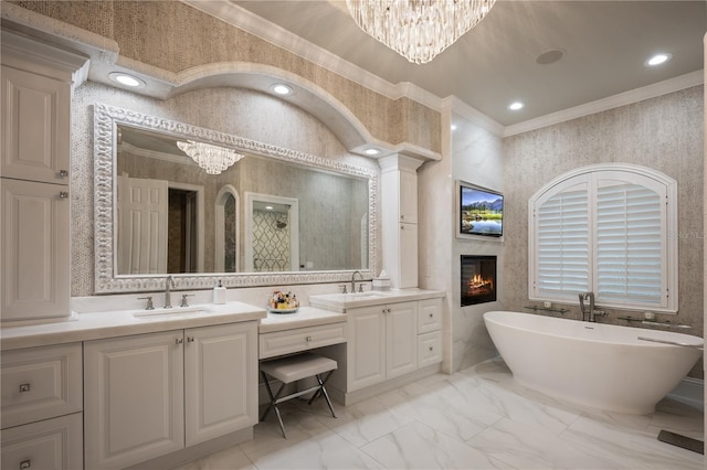 full bath with a chandelier, ornamental molding, marble finish floor, and a sink