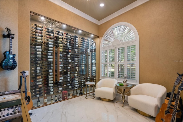 wine cellar with marble finish floor, ornamental molding, and a textured wall