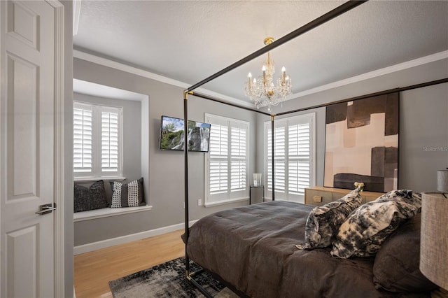 bedroom featuring multiple windows, a notable chandelier, wood finished floors, and crown molding