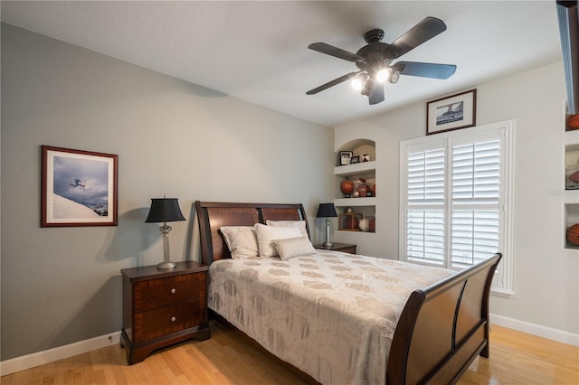 bedroom with baseboards, ceiling fan, and light wood finished floors