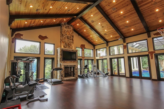 interior space featuring wooden ceiling, high vaulted ceiling, french doors, and a fireplace