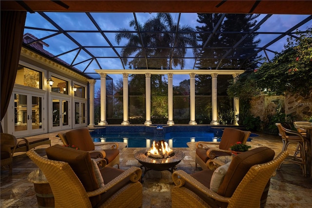 pool at dusk with an outdoor living space, french doors, and a patio