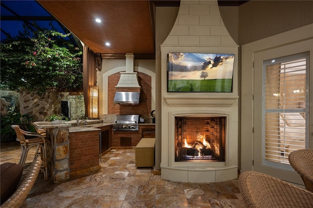 view of patio featuring a sink, exterior kitchen, area for grilling, and a large fireplace