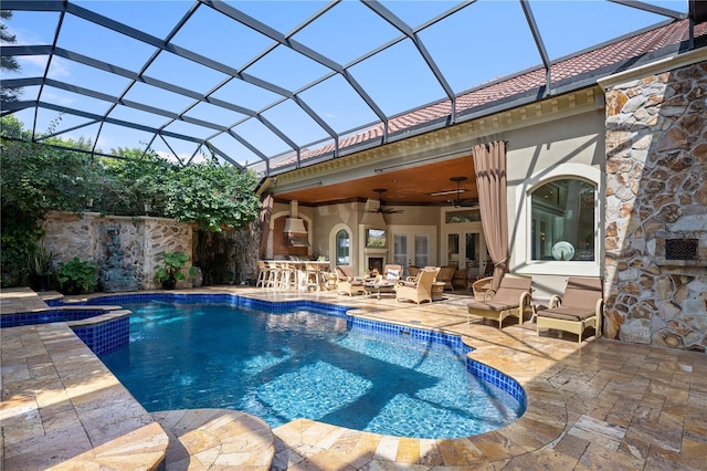 view of swimming pool featuring a patio, a pool with connected hot tub, ceiling fan, french doors, and outdoor dry bar