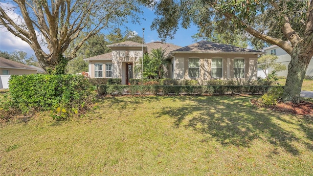 view of front of home with a front lawn and stucco siding