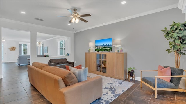 living area featuring dark tile patterned flooring, ornamental molding, and baseboards