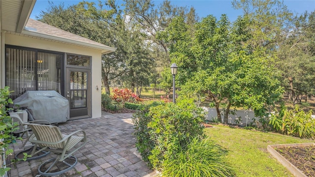 view of patio featuring grilling area and fence