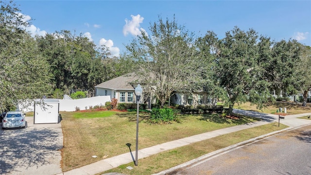 view of front of house with fence and a front yard