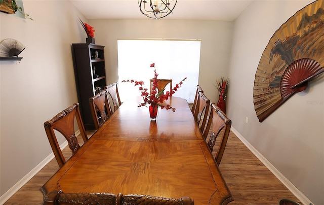 dining area featuring dark wood-type flooring and baseboards