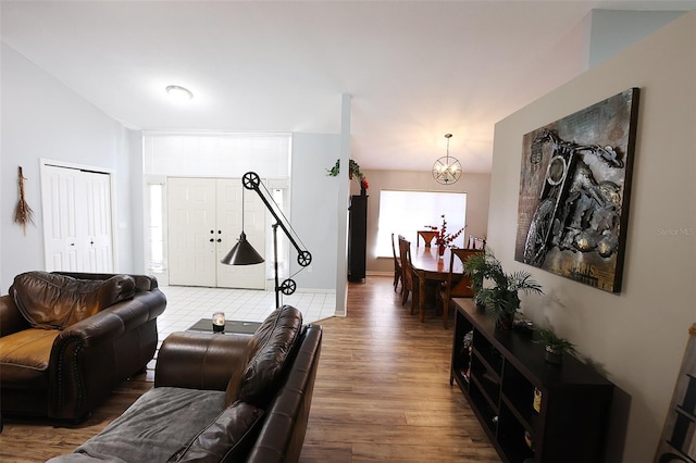 living room featuring wood finished floors and a notable chandelier