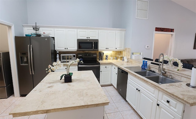 kitchen featuring black appliances, white cabinetry, high vaulted ceiling, a sink, and light tile patterned flooring