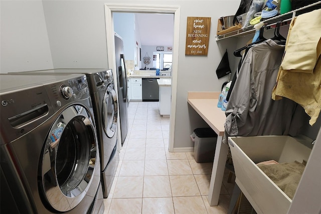 washroom featuring laundry area, light tile patterned flooring, and separate washer and dryer