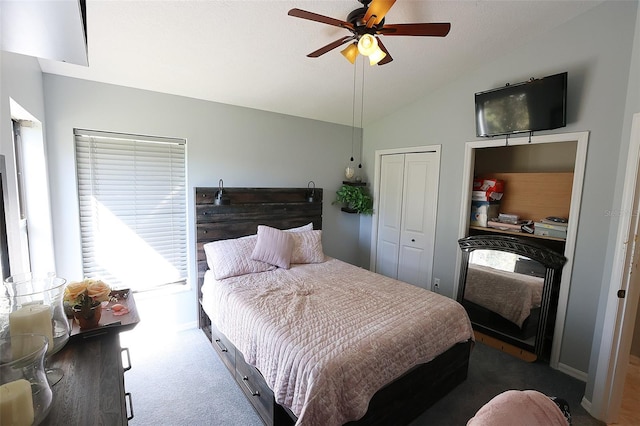 carpeted bedroom featuring lofted ceiling, ceiling fan, and a closet